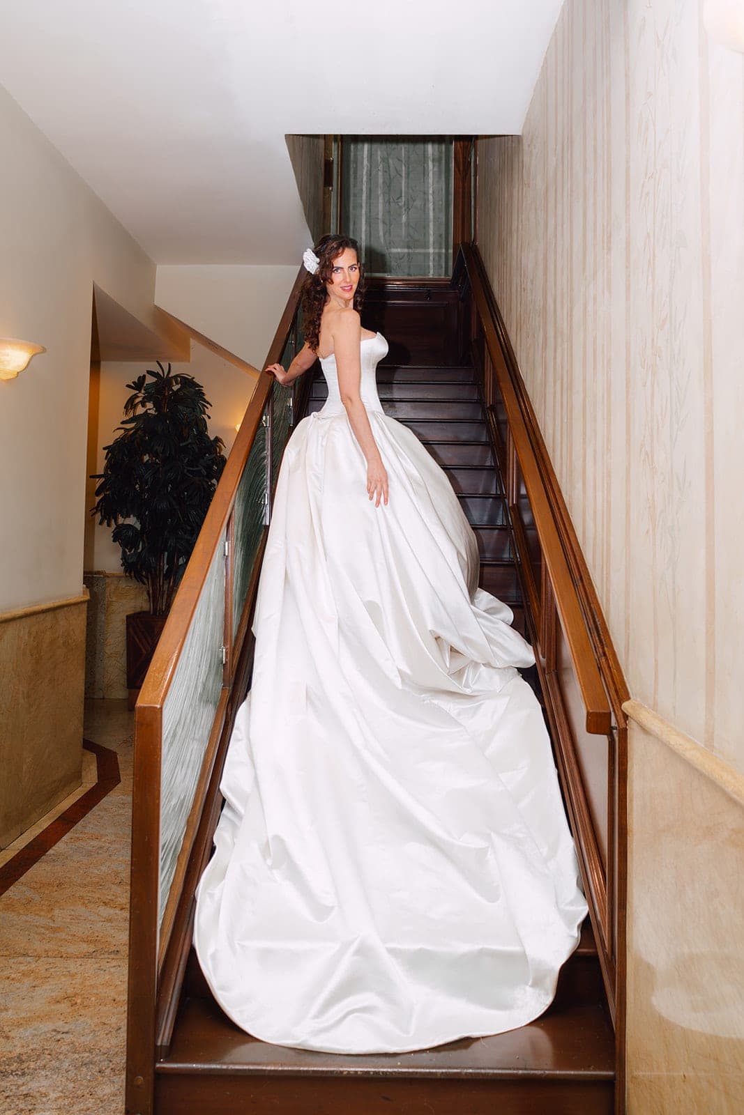 The Camille's long train sweeping down a staircase