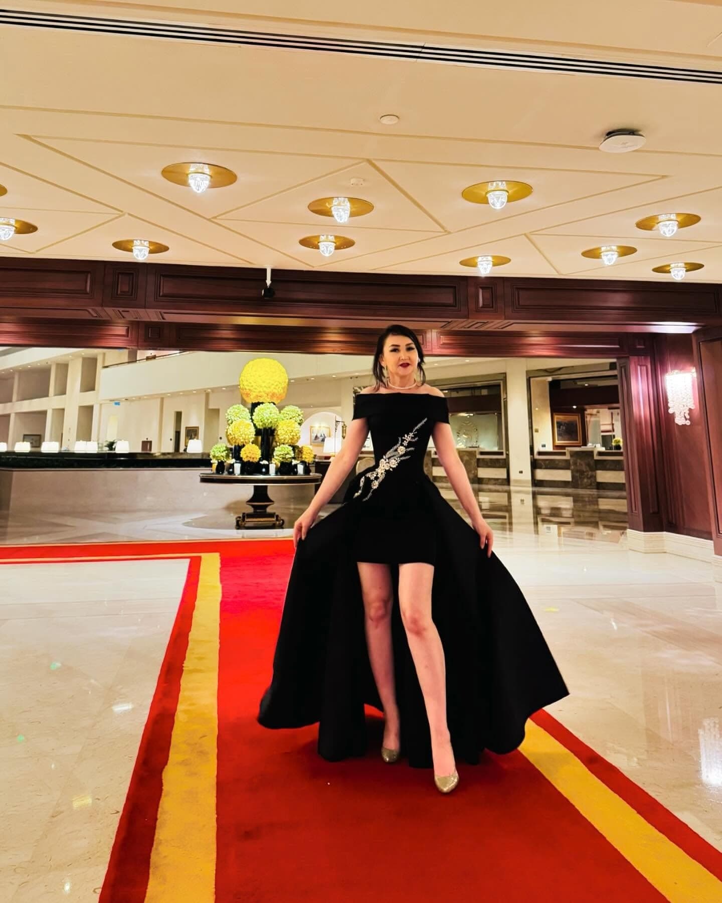 Oko Tilyeukhan wearing a black evening gown of her own design