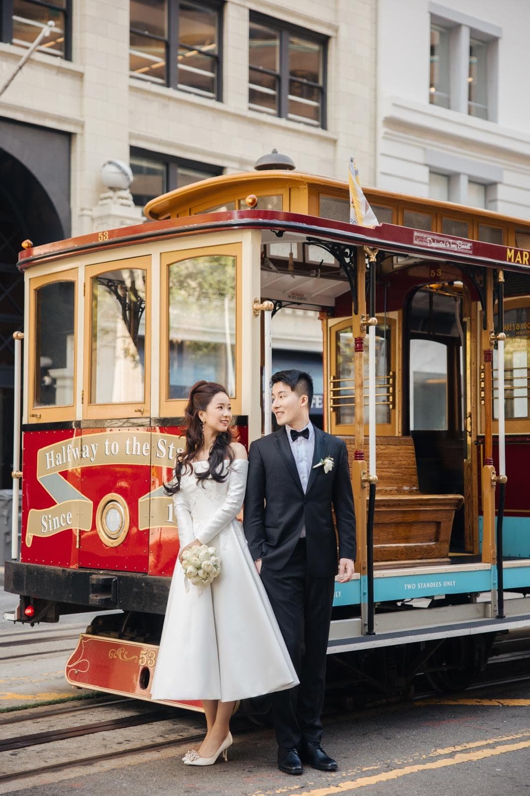 OT Haute Couture bride photographed beside a San Francisco cable car